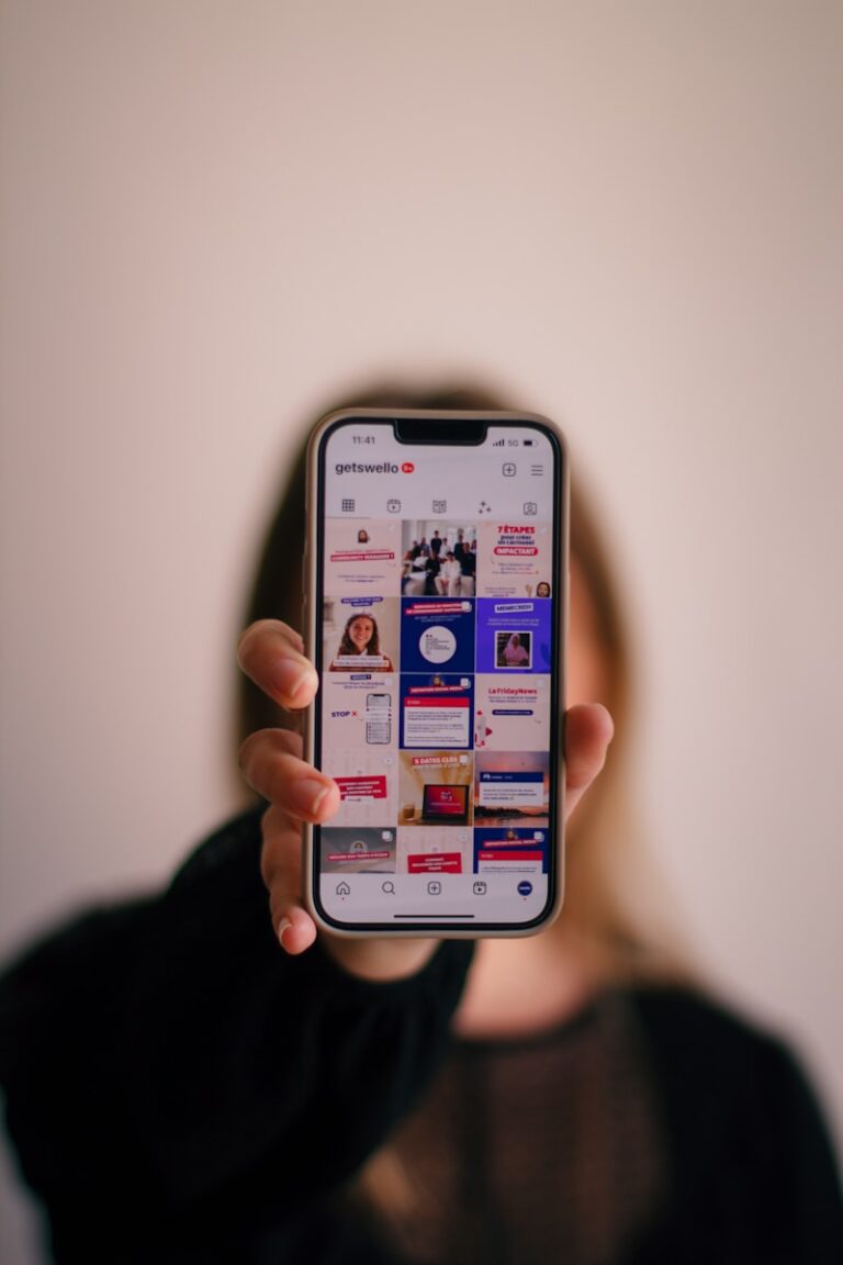 a woman holding up a cell phone in front of her face